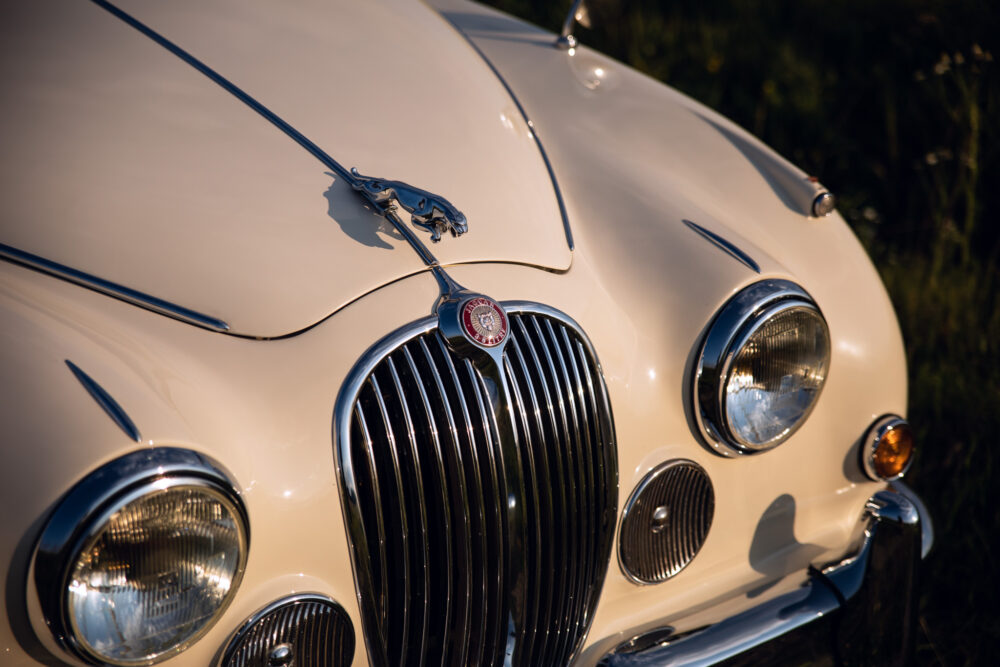 Vintage Jaguar car front close-up at sunset