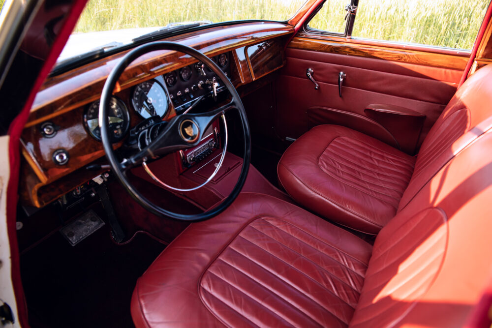 Vintage car interior with red leather seats and dashboard