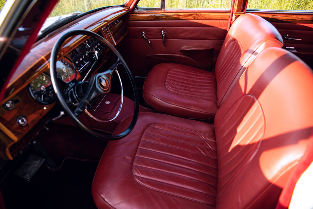 Vintage car interior with red leather seats and dashboard