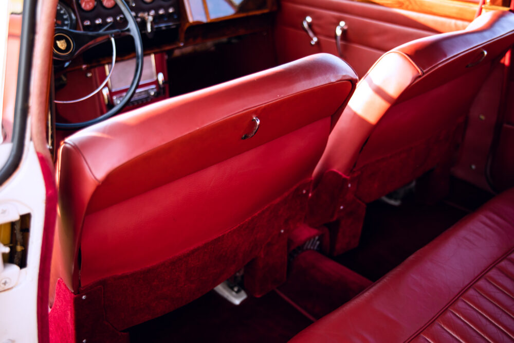 Vintage red car interior, leather seats and dashboard