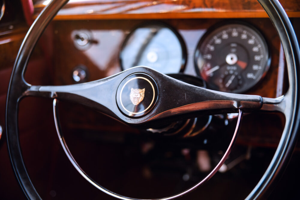 Vintage car steering wheel with emblem close-up