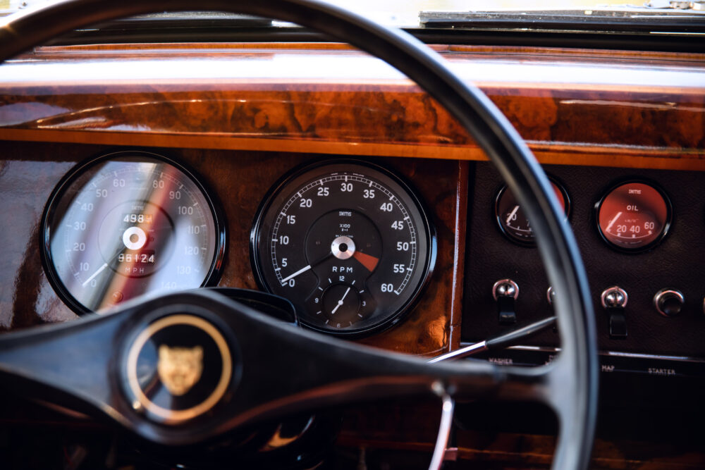 Vintage car dashboard with wooden trim and gauges