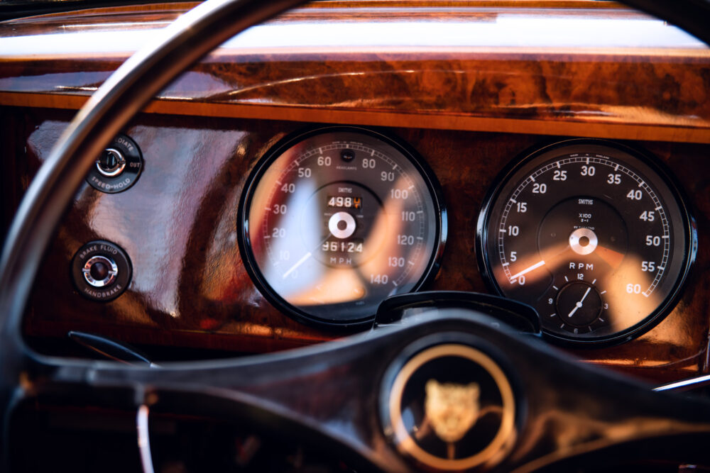 Vintage car dashboard with wooden trim and classic gauges