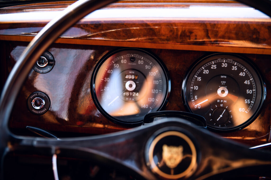Vintage car dashboard with wooden trim and classic gauges