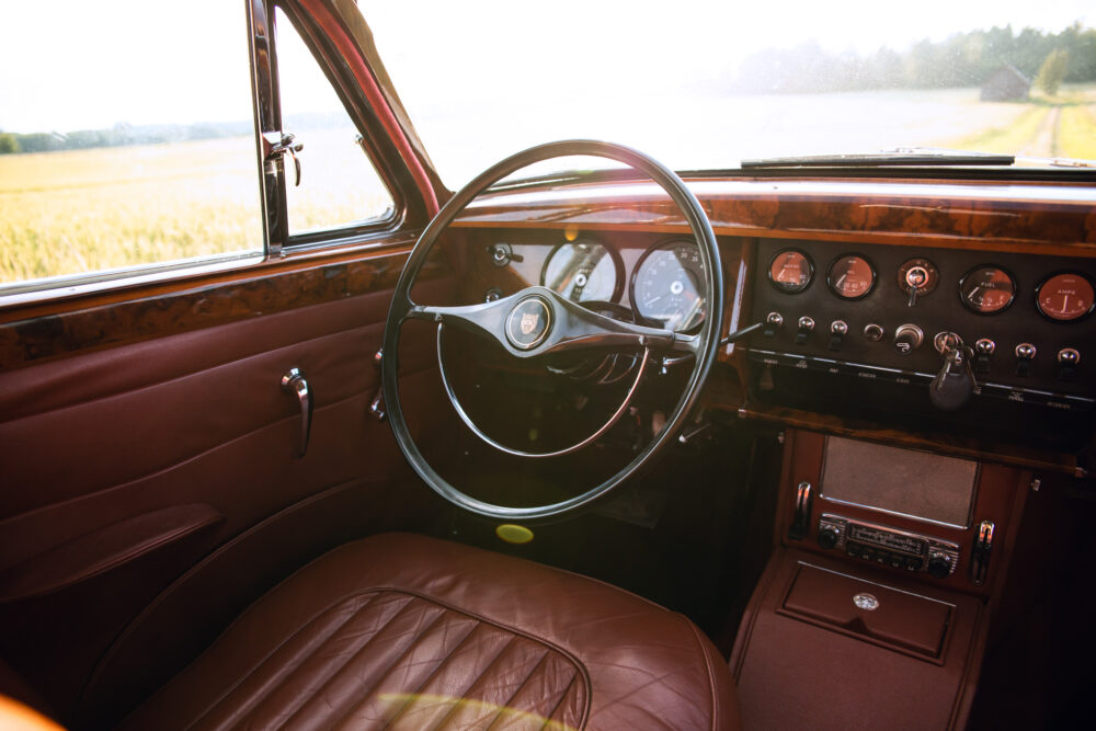 Vintage car interior with wooden dashboard and leather seats