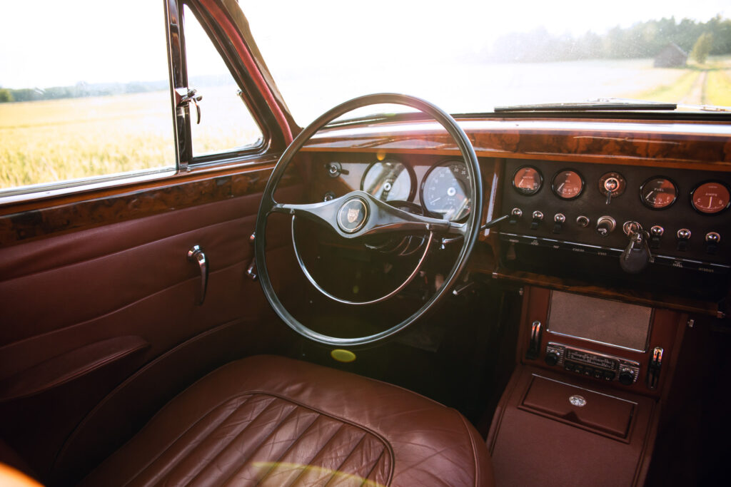 Vintage car interior with wooden dashboard and leather seats