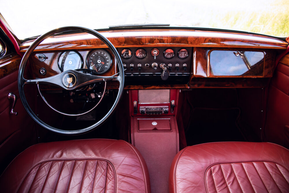 Vintage car interior with red leather seats and dashboard