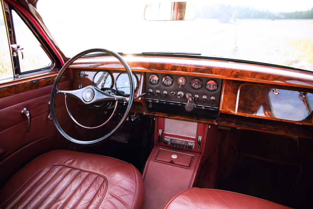 Vintage car interior with red leather seats and dashboard