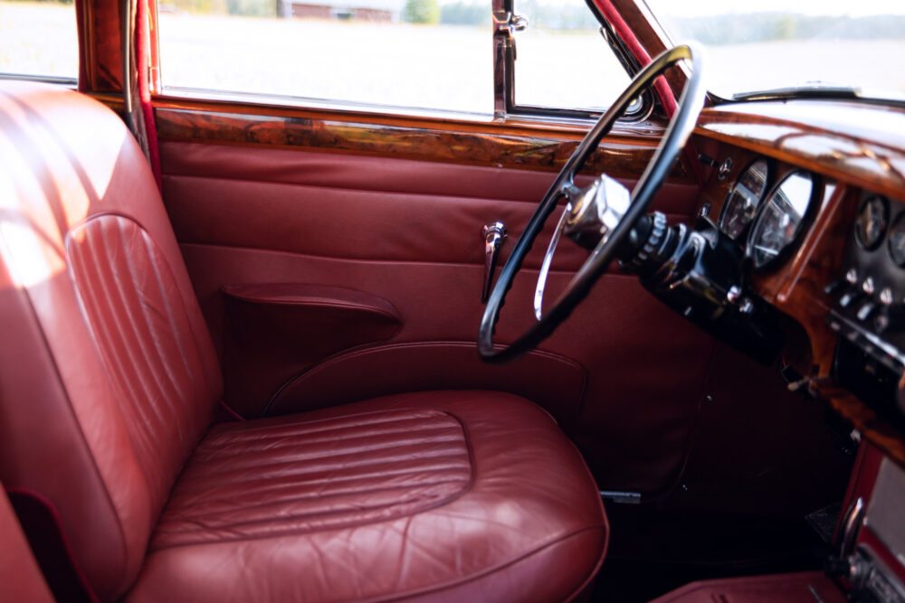 Vintage car interior with red leather seats and dashboard