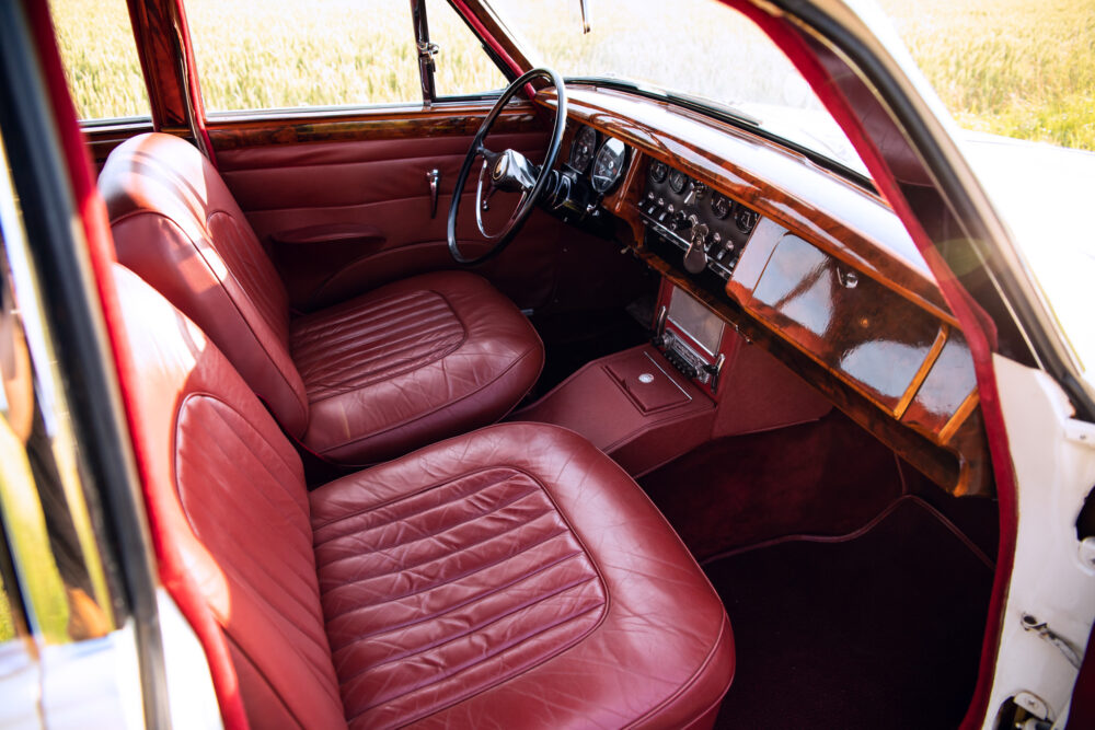 Vintage car interior with red leather seats and dashboard