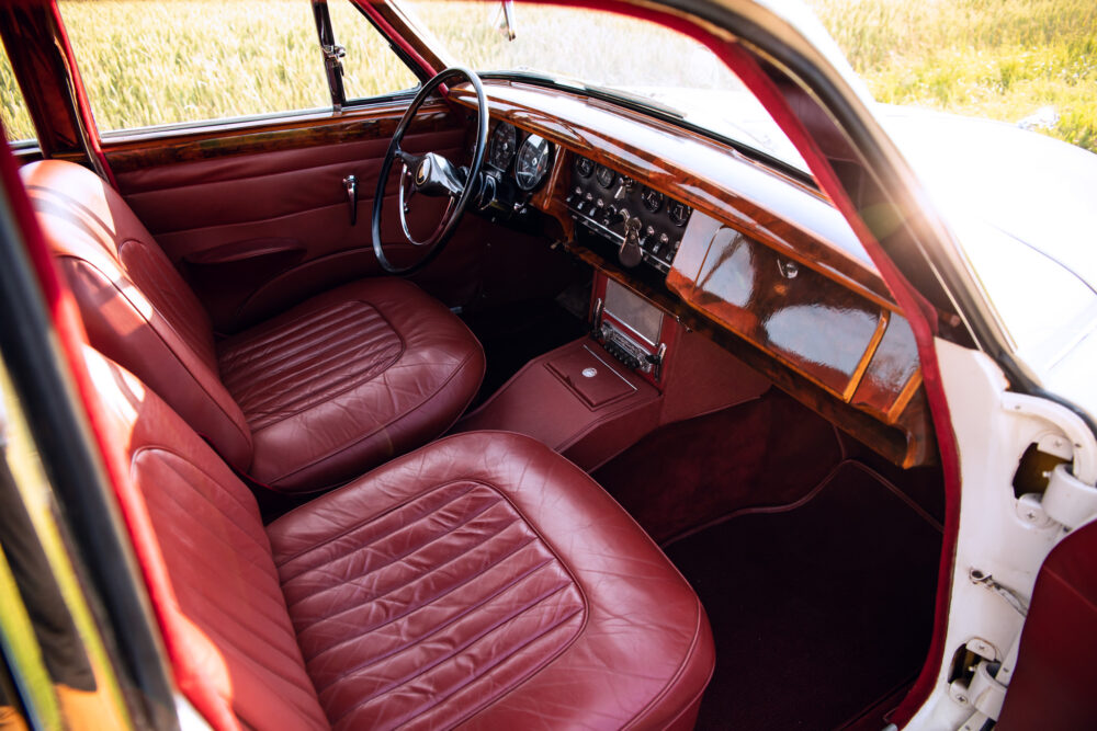 Vintage car interior with red leather seats and dashboard