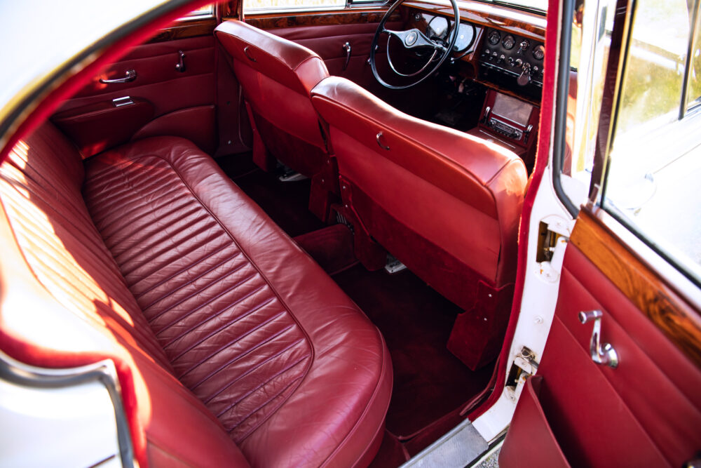 Vintage car interior with red leather seats and dashboard