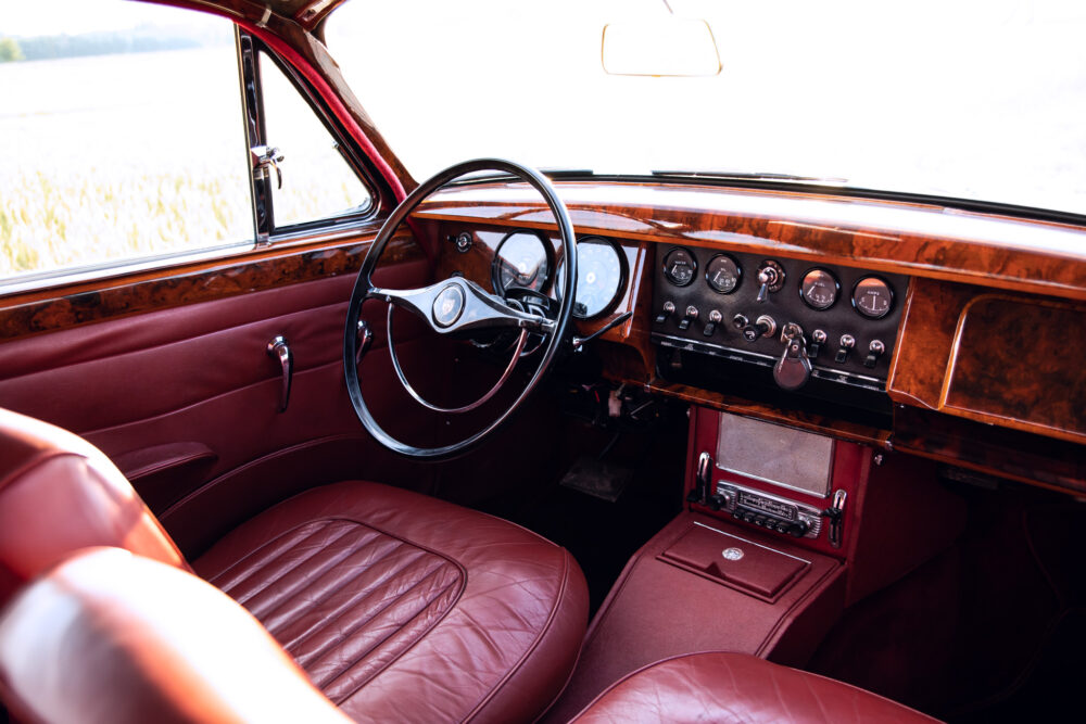 Vintage car interior with leather seats and wooden dashboard