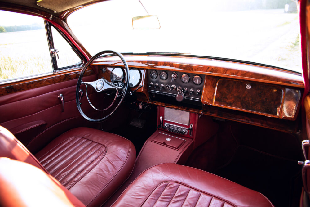 Vintage car interior with red leather seats and dashboard