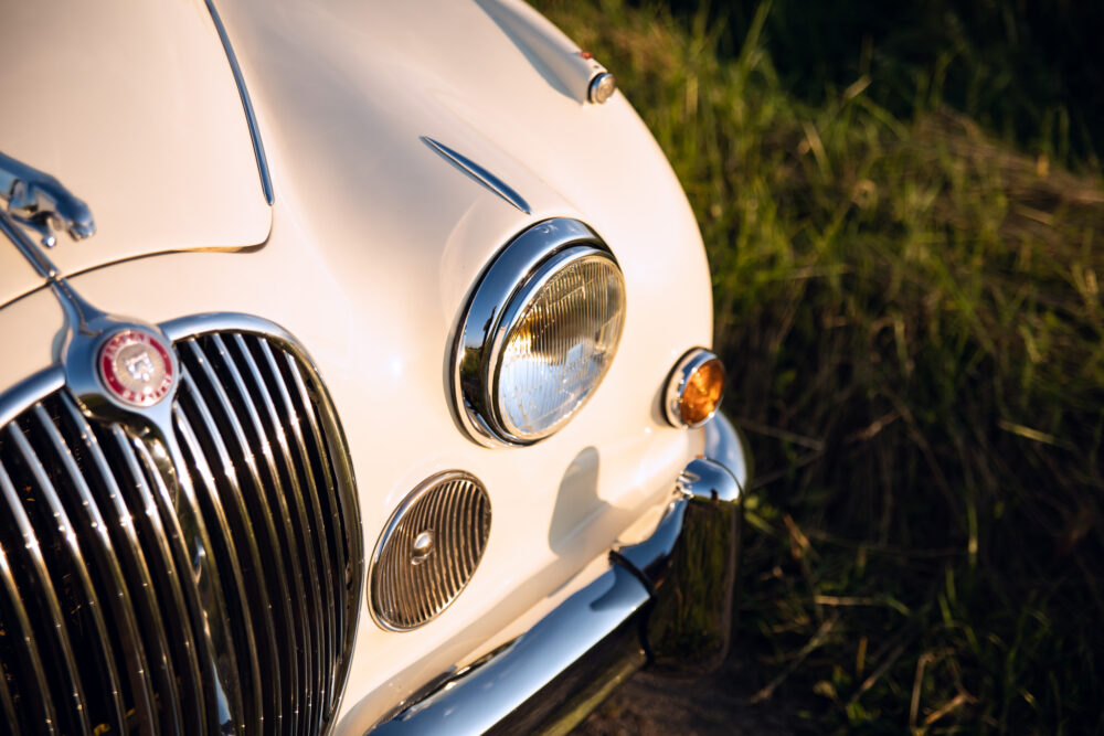 Vintage white car front detail at sunset