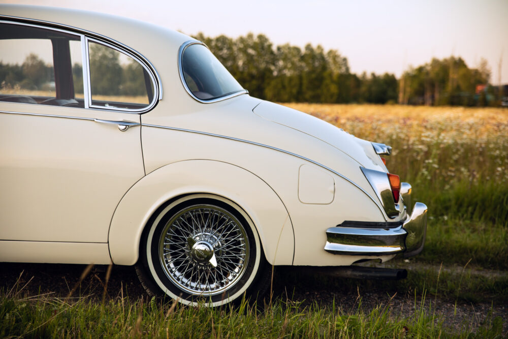 Vintage white car parked in a rural field