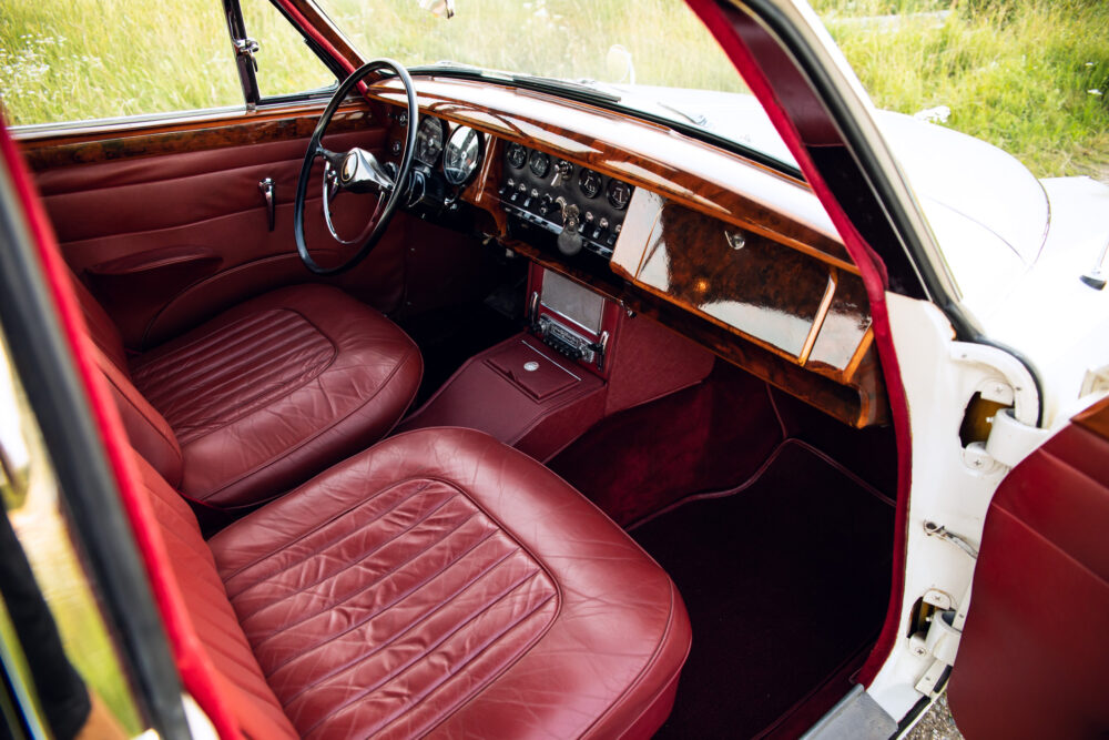 Vintage car interior with red leather seats and dashboard