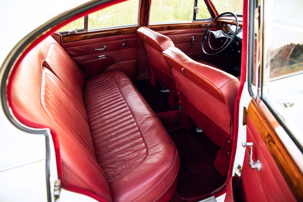 Vintage car interior with red leather seats and wood trim