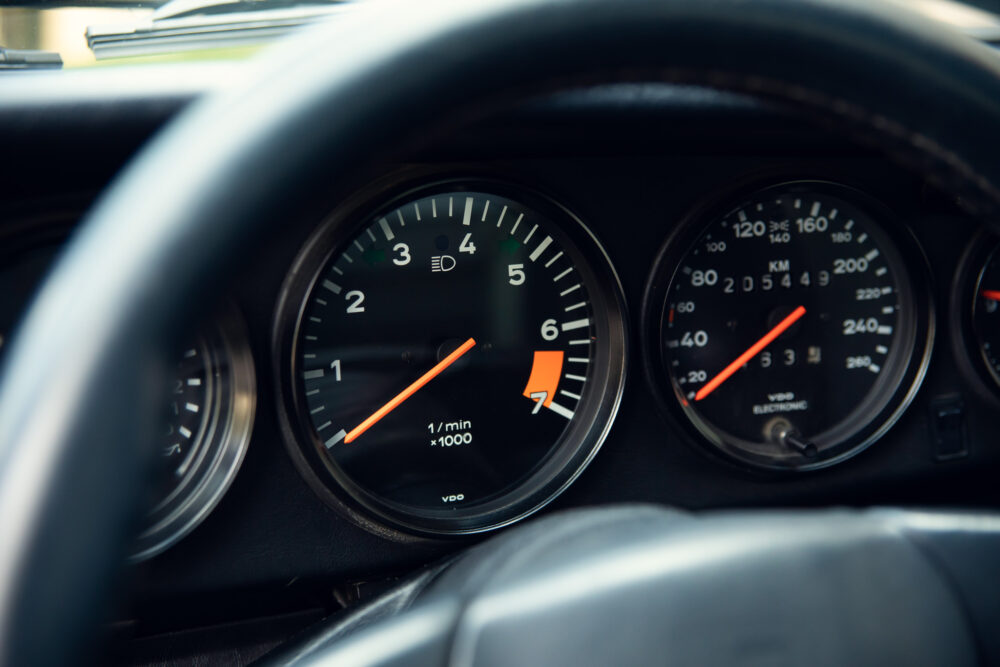 Close-up view of car dashboard with speedometer and tachometer
