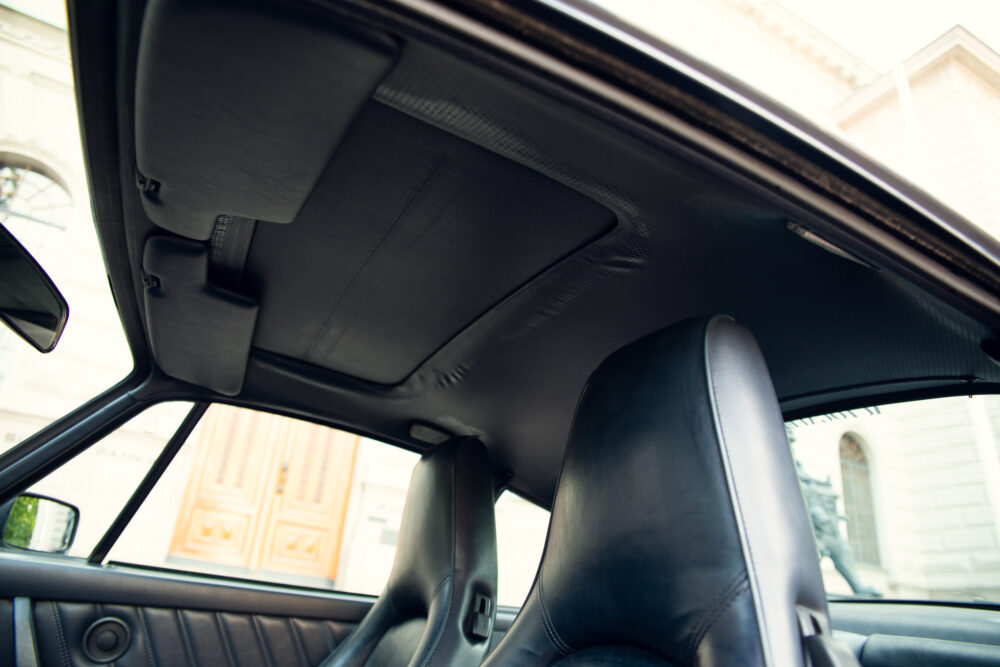 Luxury car interior with leather seats and sunroof