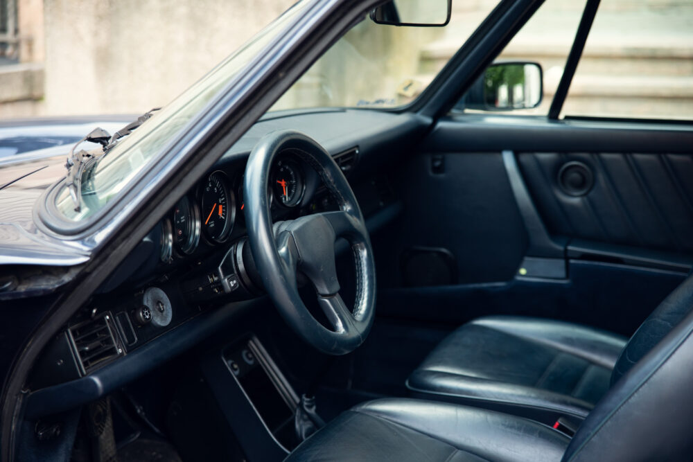 Vintage car interior, steering wheel and dashboard view