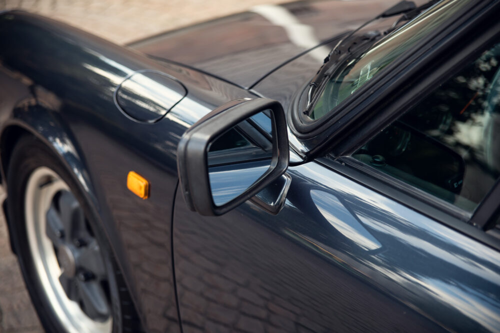 Close-up of a sleek sports car's side mirror