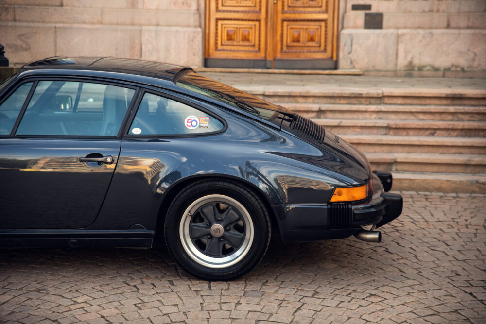 Vintage black Porsche 911 by stone steps
