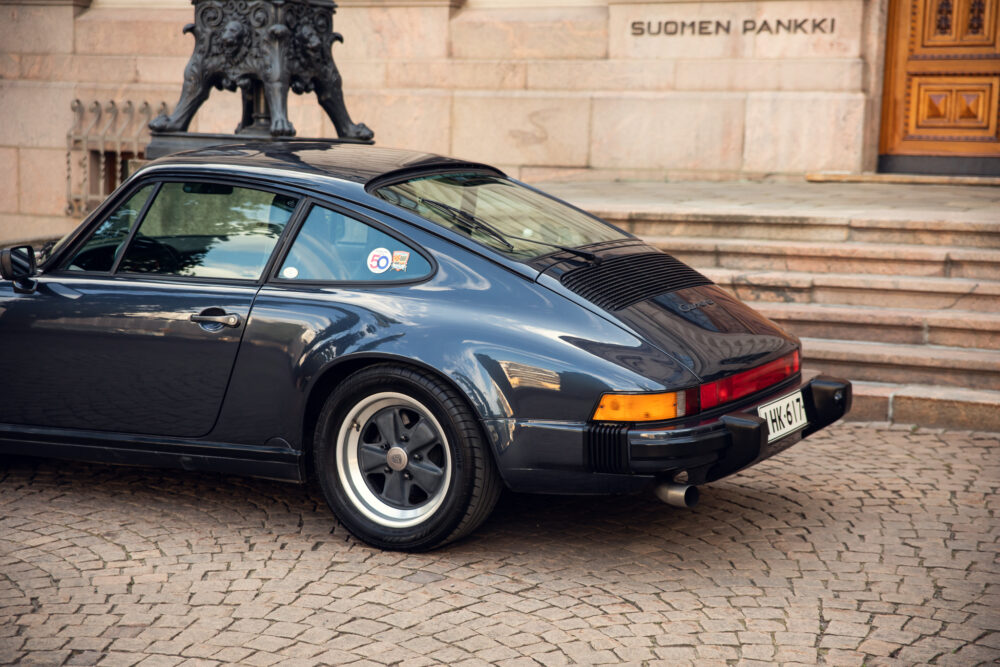 Vintage Porsche 911 Carrera outside a historic building
