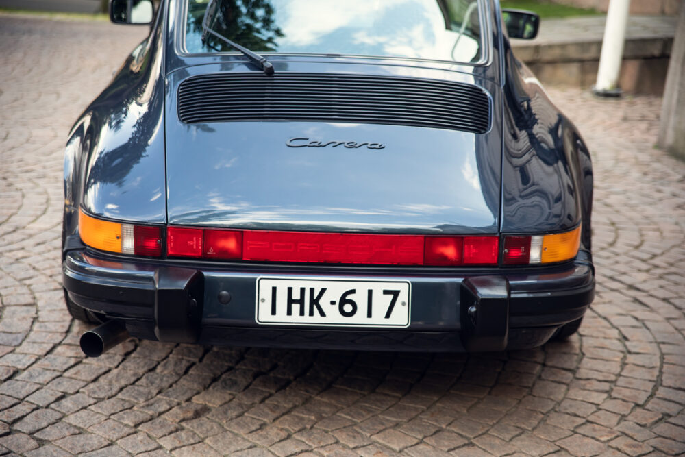Rear view of a black Porsche Carrera parked outdoors