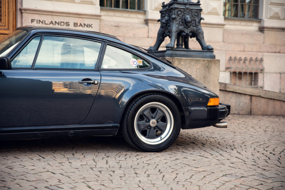 Vintage black car parked near Finland's Bank building