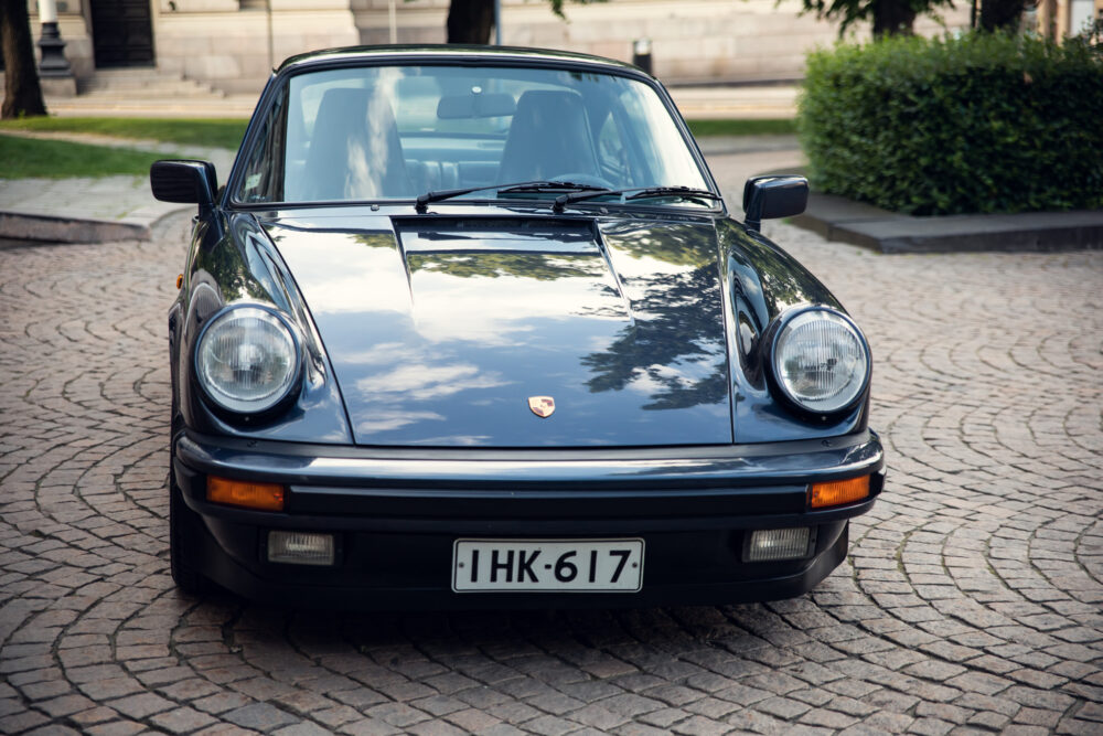 Vintage Porsche car parked on cobblestone street