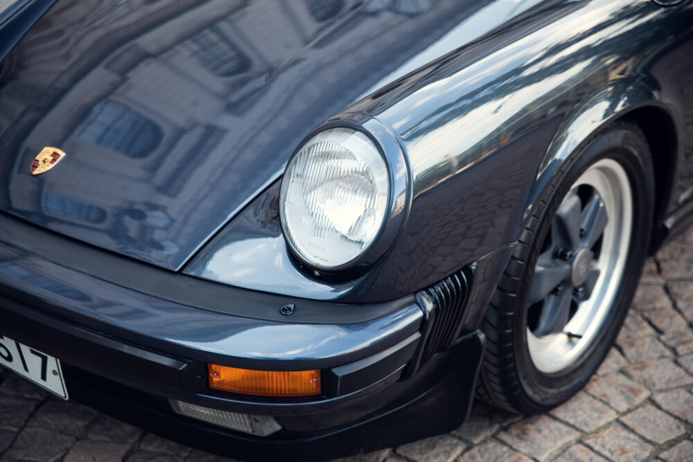 Close-up of classic black Porsche car front detail