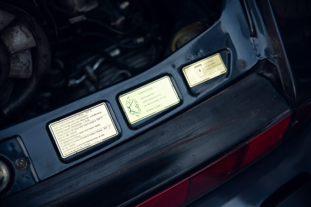 Close-up of warning labels on vintage car engine