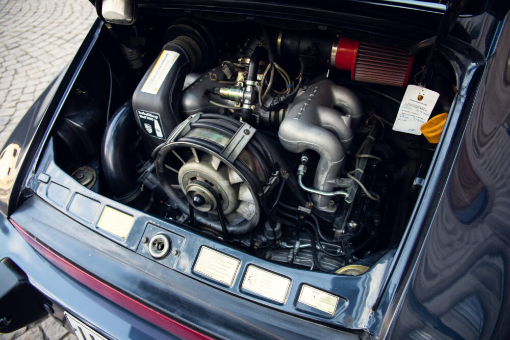 Vintage car engine bay with visible modifications