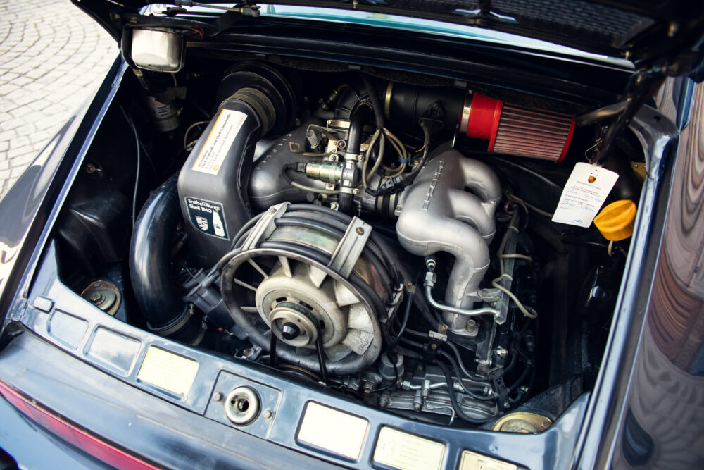 Detailed view of a classic car's open engine compartment