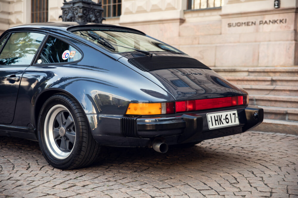 Vintage Porsche Carrera by a historic building