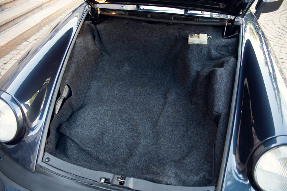 Open trunk of a vintage car showing clean interior