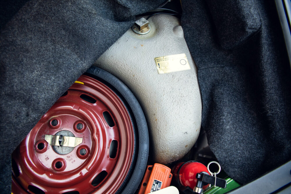 Car trunk with spare tire, toolkit, and safety items