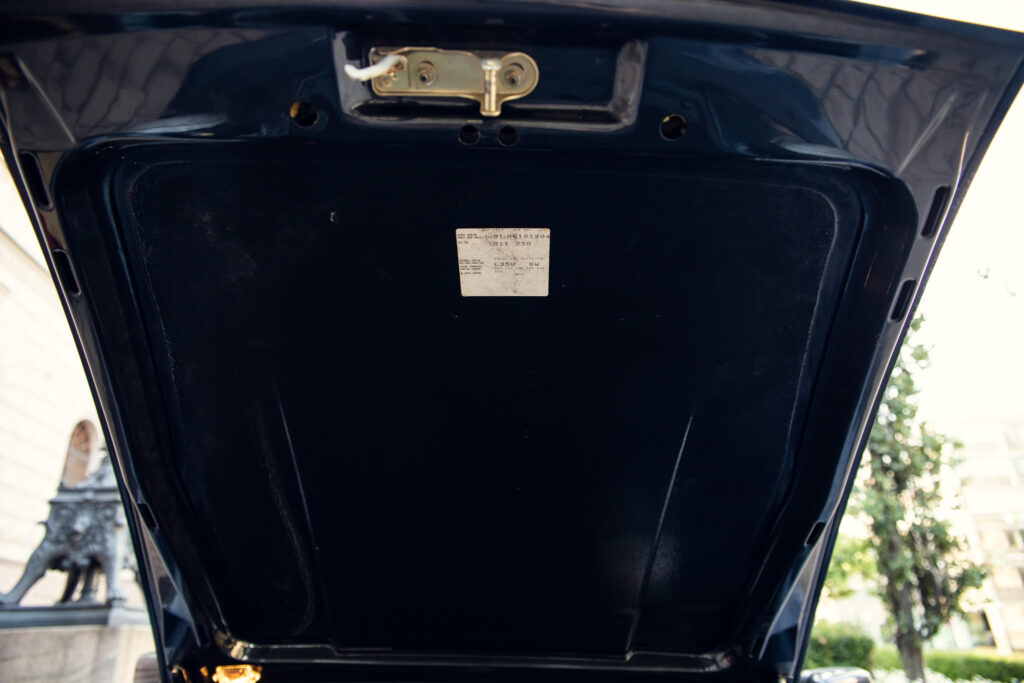 Car trunk open showing interior and label