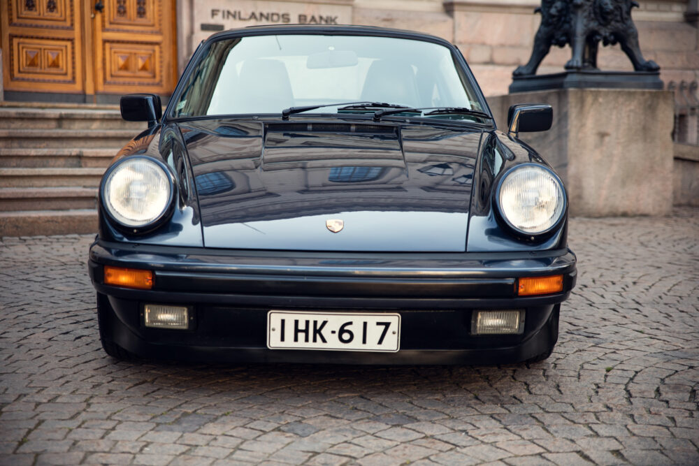 Vintage Porsche car in front of historic building