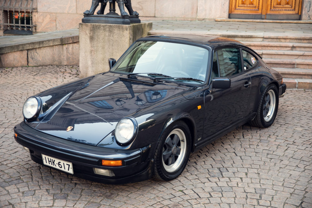 Vintage black Porsche sports car on cobblestone
