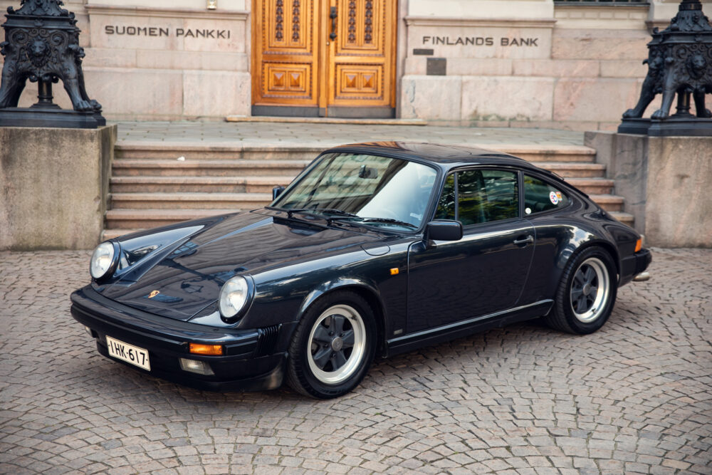 Vintage black Porsche in front of Finland's Bank