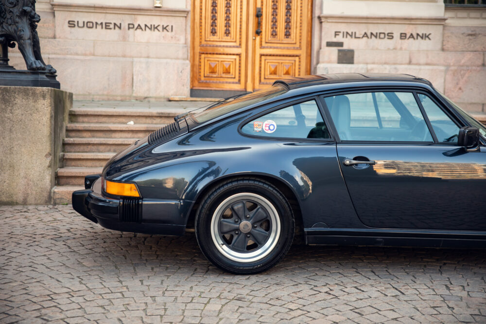 Vintage Porsche parked outside Finland's Bank building