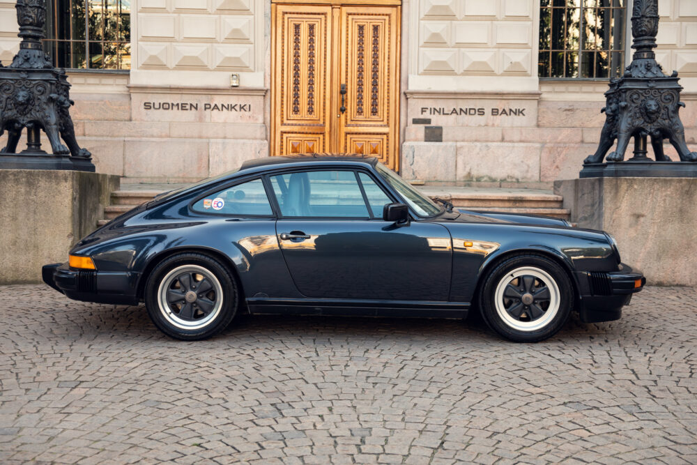 Vintage black Porsche car parked outside Finland's Bank