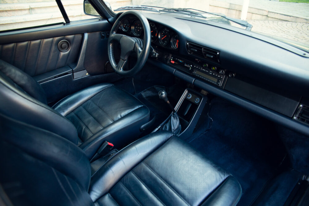 Vintage car's sleek black leather interior with dashboard