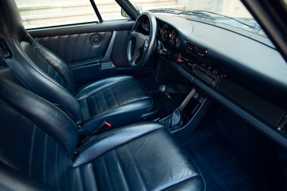 Vintage car interior with leather seats and manual gearbox
