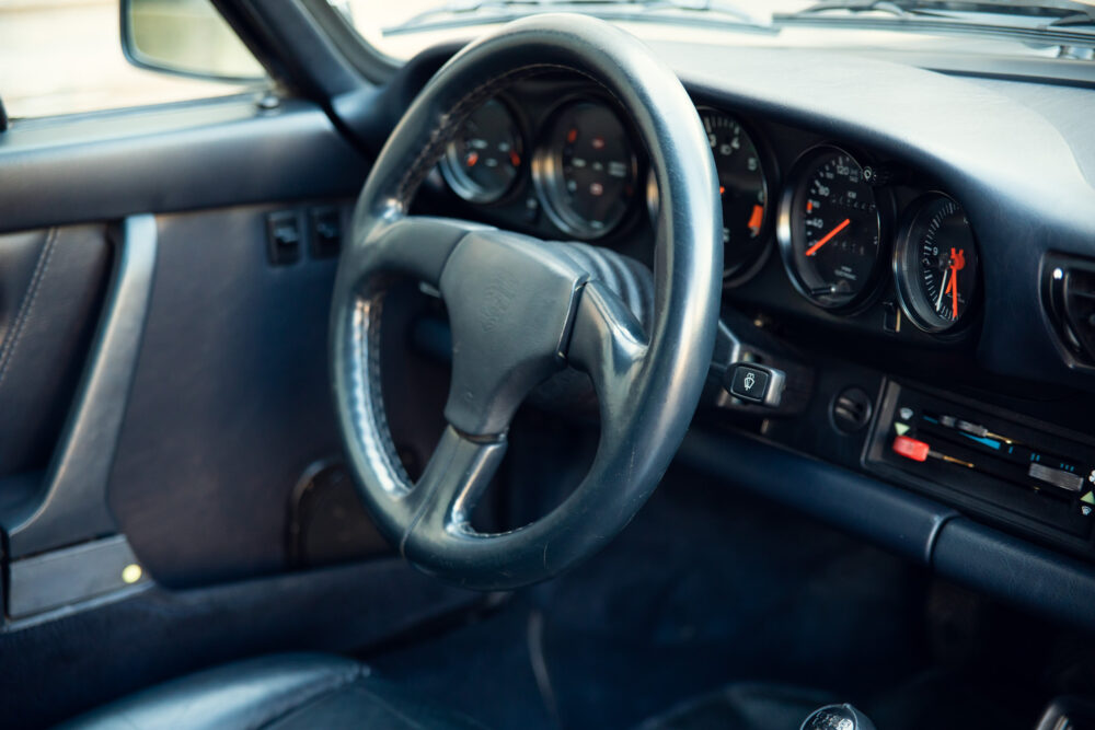 Vintage car's dashboard with steering wheel and gauges