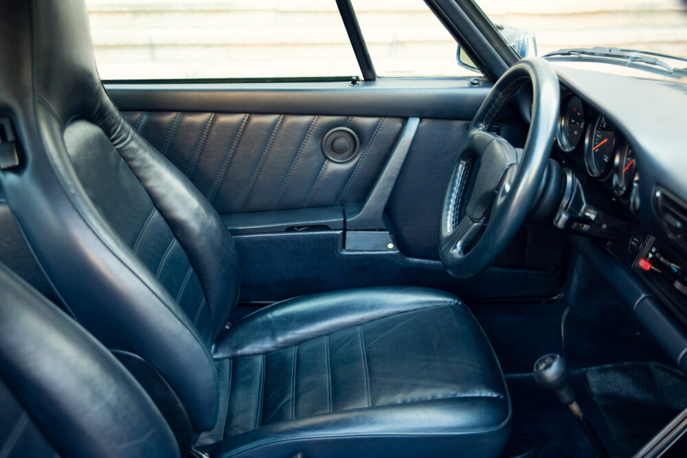 Classic car interior with black leather seats and dashboard