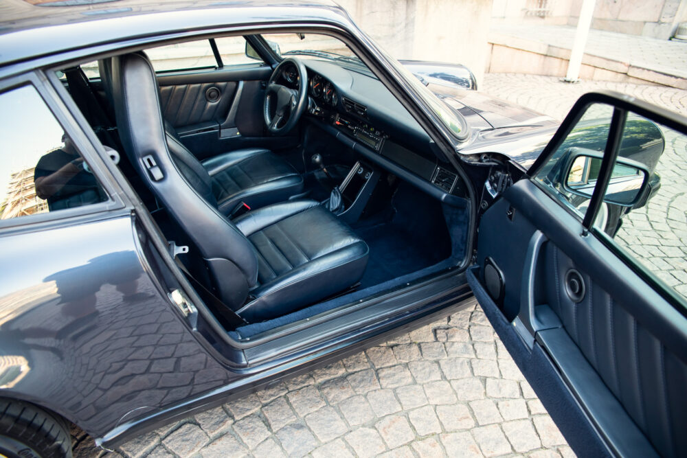 Classic car interior with open driver's door