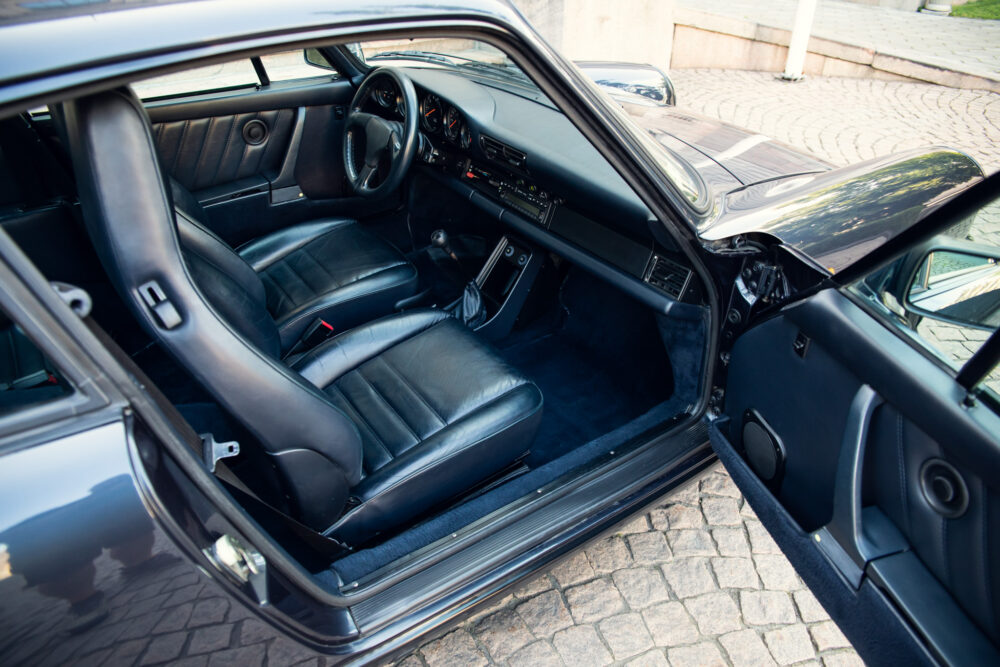 Vintage black car interior, classic design dashboard and seats